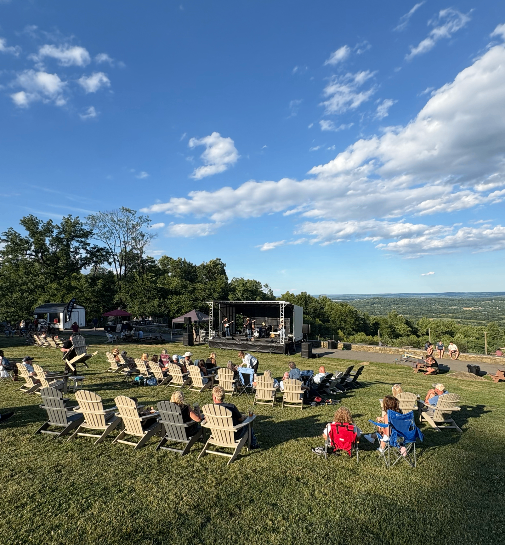 Outdoor mountaintop stage at golden hour
