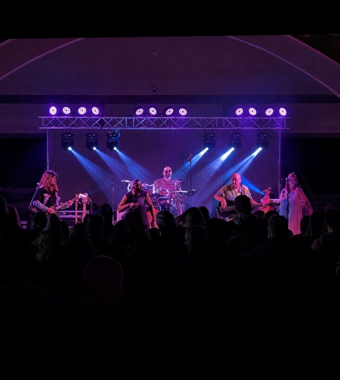 Live band under purple stage wash